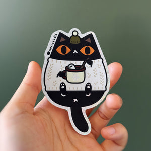 Black Cat in White Sweater Holding Hot Chocolate with Olive Green Beanie Glitter Vinyl Sticker