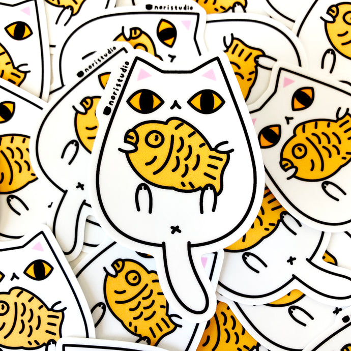 white cat with taiyaki vinyl sticker by Noristudio