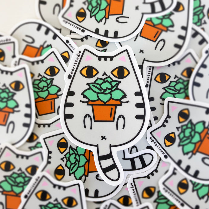 gray tabby cat with yellow eyes sticker by Noristudio